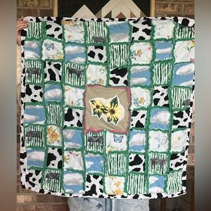 Handmade by me. Cow and flower baby quilt.
